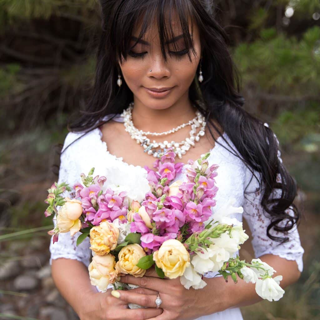 bride looking at bouquet