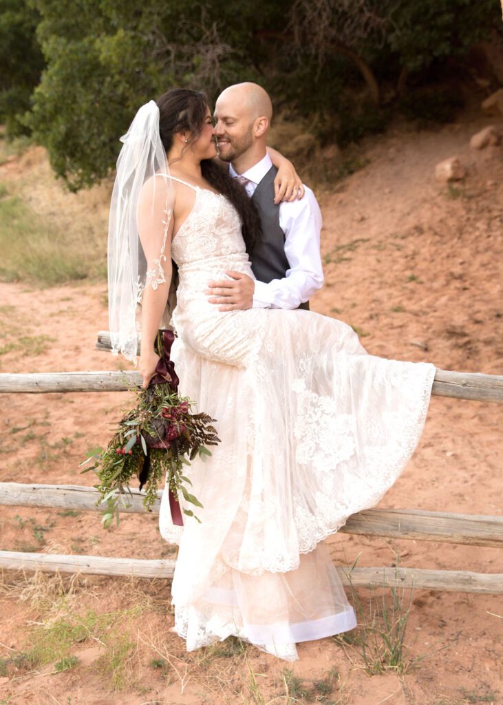 bride sitting on fence