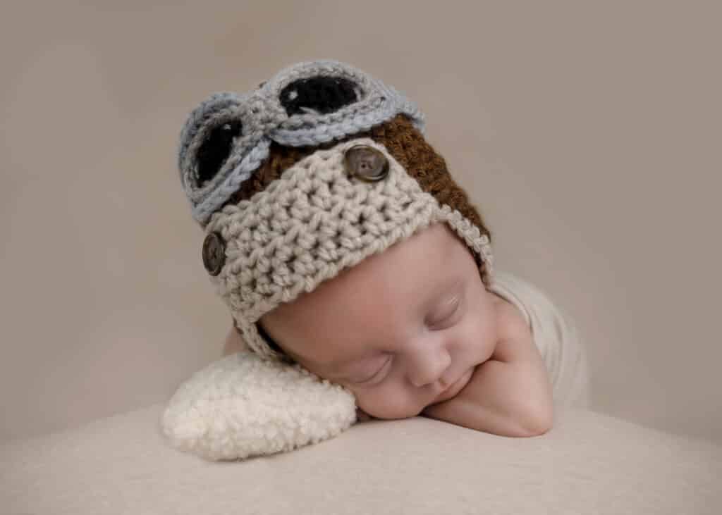 baby in pilot hat newborn photographer near me