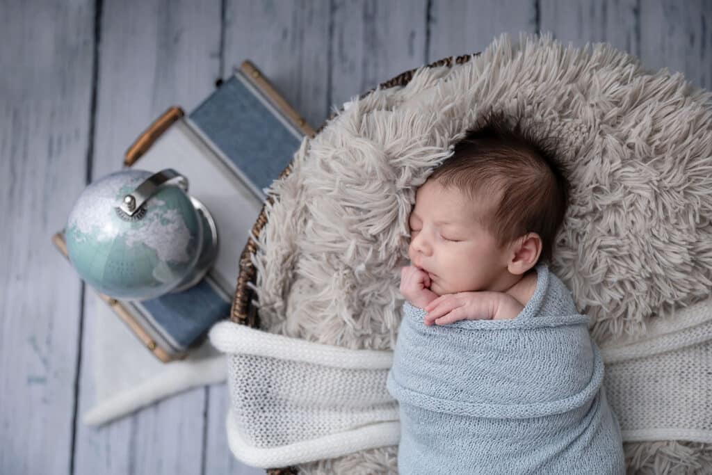 baby with globe and suitcase provo newborn portraits newborn photographer near me