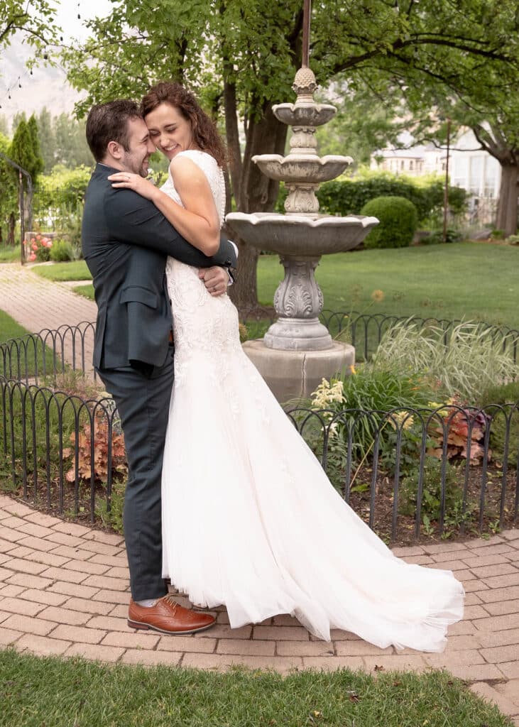 groom lifting bride into air and smiling