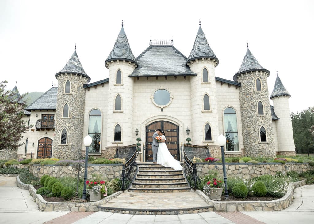 bride and groom in front of castle