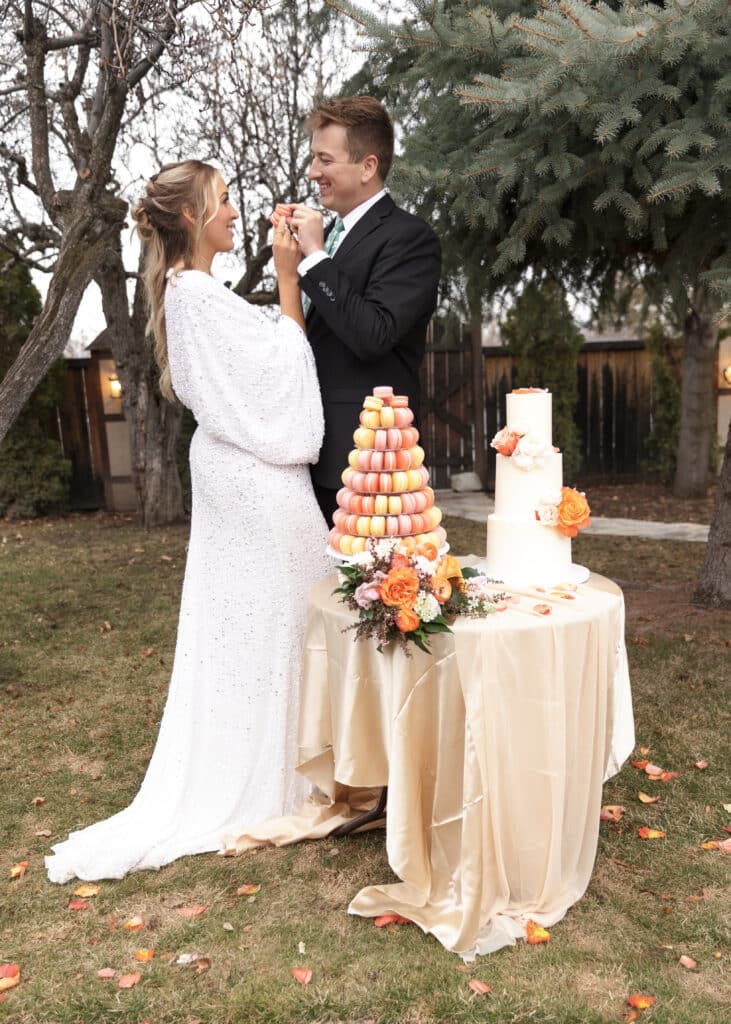 bride and groom feed each other macrons