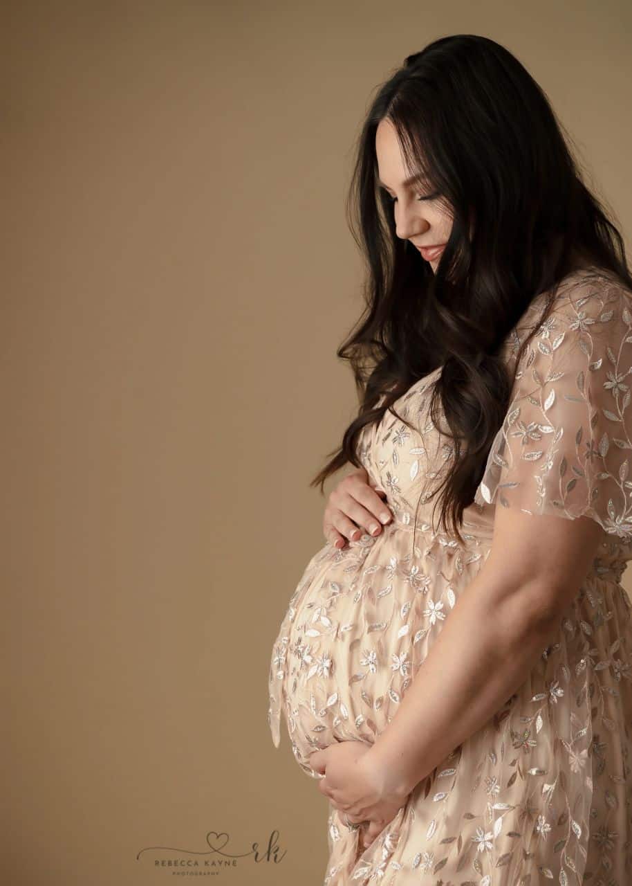 pregnant mom in sparking pink maternity gown