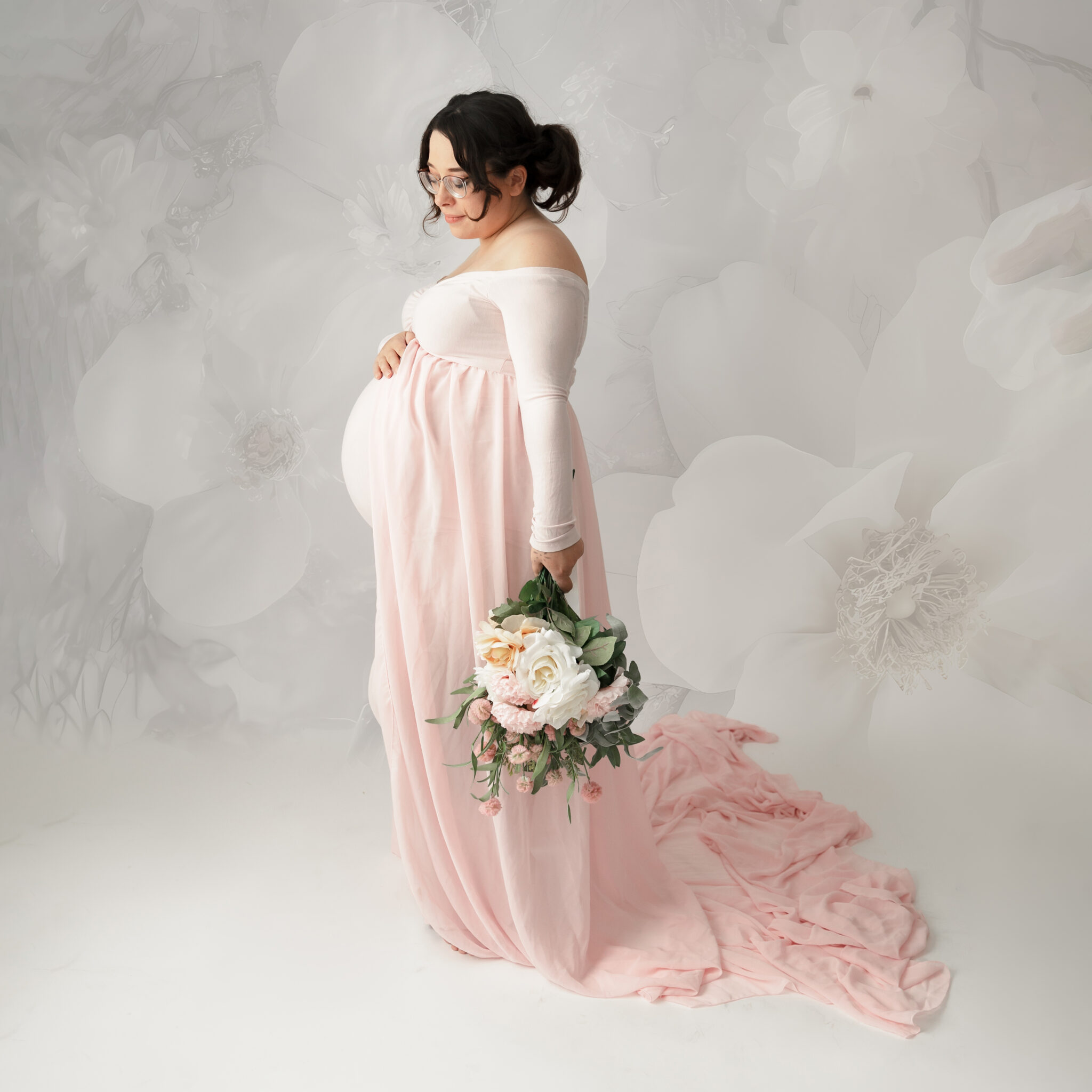 white floral backdrop with mom in pink maternity gown taken by utah county photographer