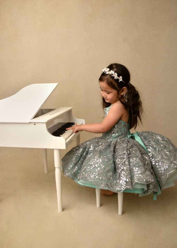 utah county princess portrait sessions little girl playing a baby grand piano