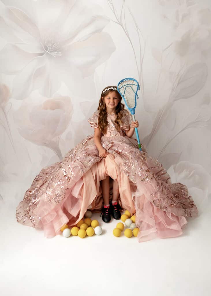 girl in princess dress with lacrosse gear for princess portrait session
