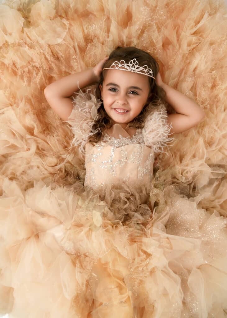Utah princess portrait sessions girl in yellow princess gown lying down on the ground
